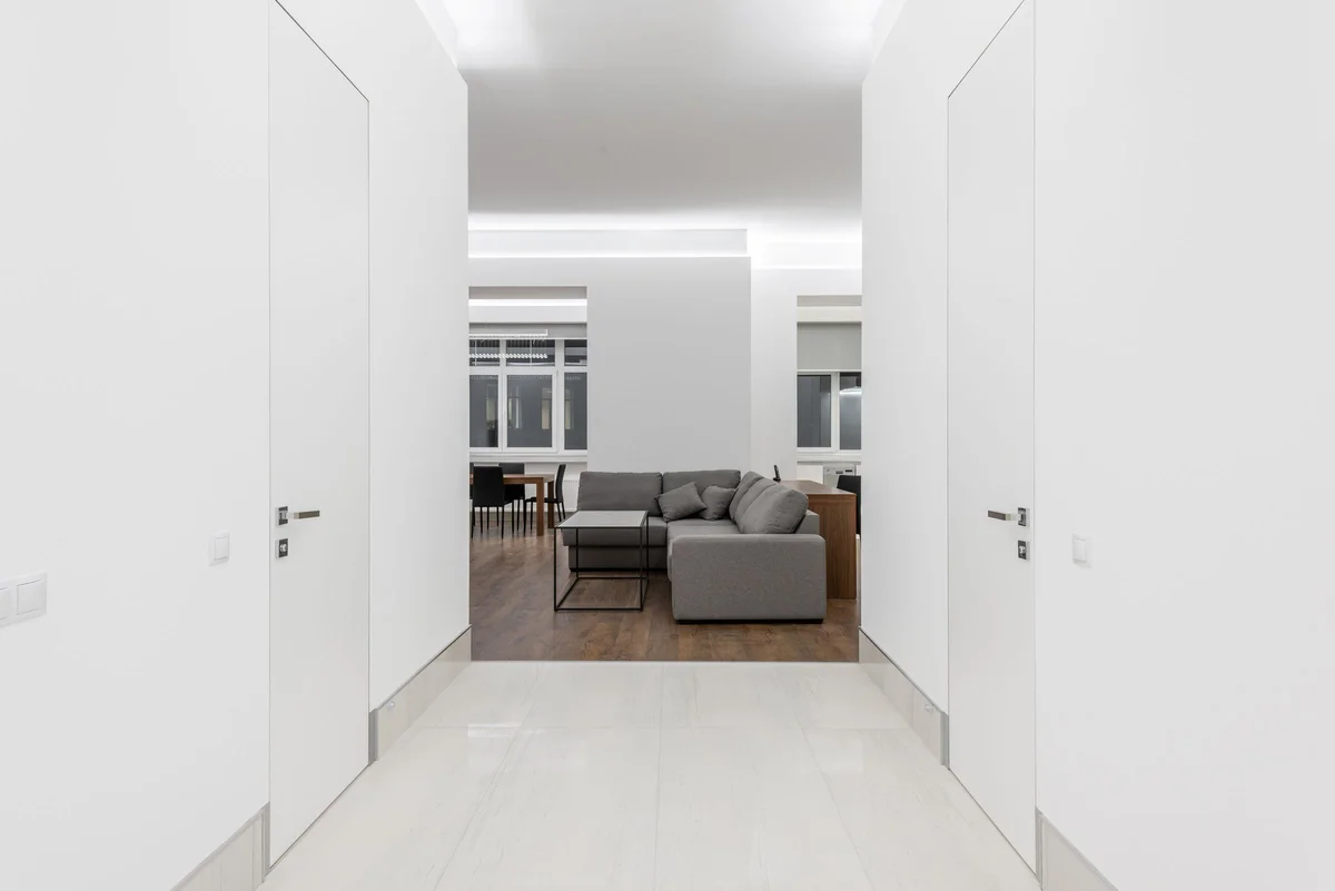 White walls and crisp ceiling junctions opening onto a living room